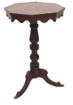 A Victorian mahogany occasional table, the octagonal top with a shaped apron on a turned column and