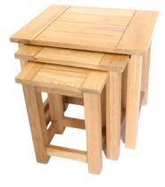 A nest of three light oak tables, of plain form, 50cm wide.