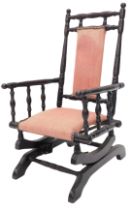 A late 19thC ebonised child's American style rocking chair, with a padded back and seat.