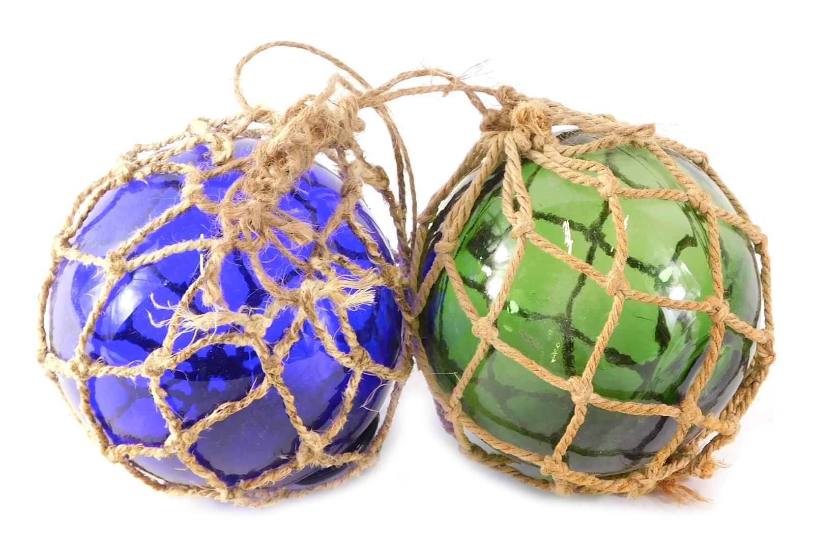 Two coloured glass fishing floats, with string binding.