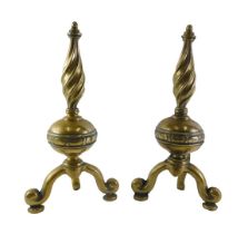 A pair of brass fire dogs, each with twisted finials and splayed legs, 42cm high.