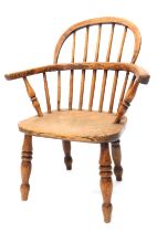 A 19thC child's ash and elm Windsor chair, with solid seat, on turned legs.