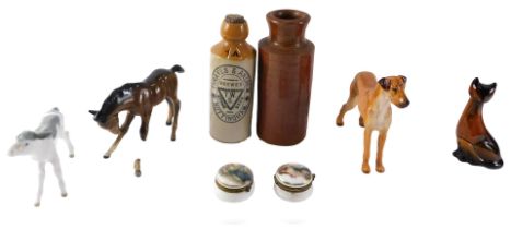 A Royal Doulton ceramic Great Dane, other ceramic animals, two stoneware bottles, a jar, and two Con