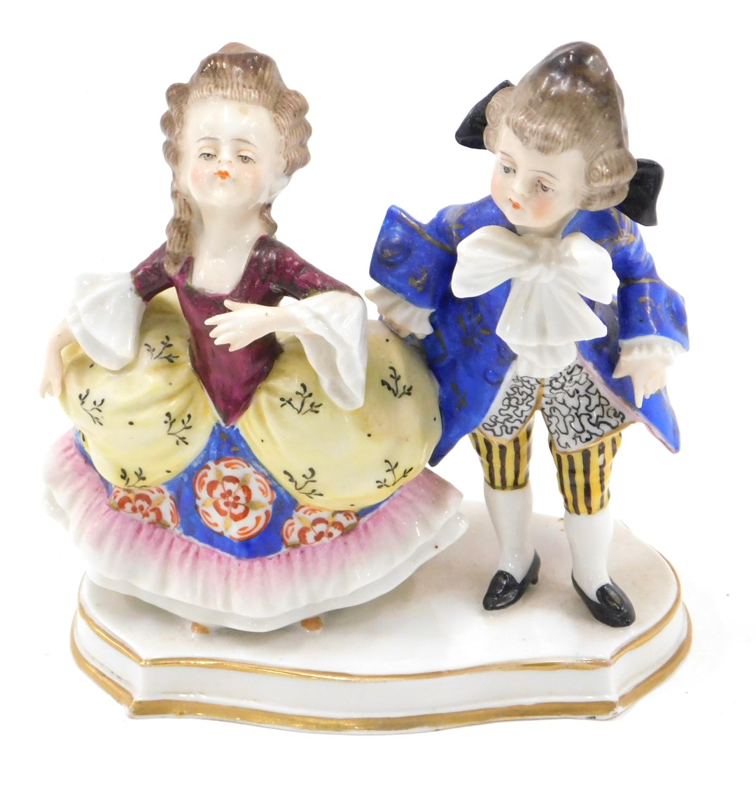 A Continental porcelain figure group, modelled in the form of two children in 18thC dress, on shaped