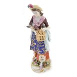 A Continental porcelain figure, modelled in the form of a lady with a bird and cage, gold anchor mar