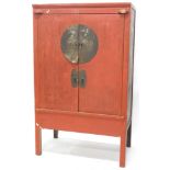 A Chinese red painted cabinet, with metal mounts, 182cm high, 110cm wide.