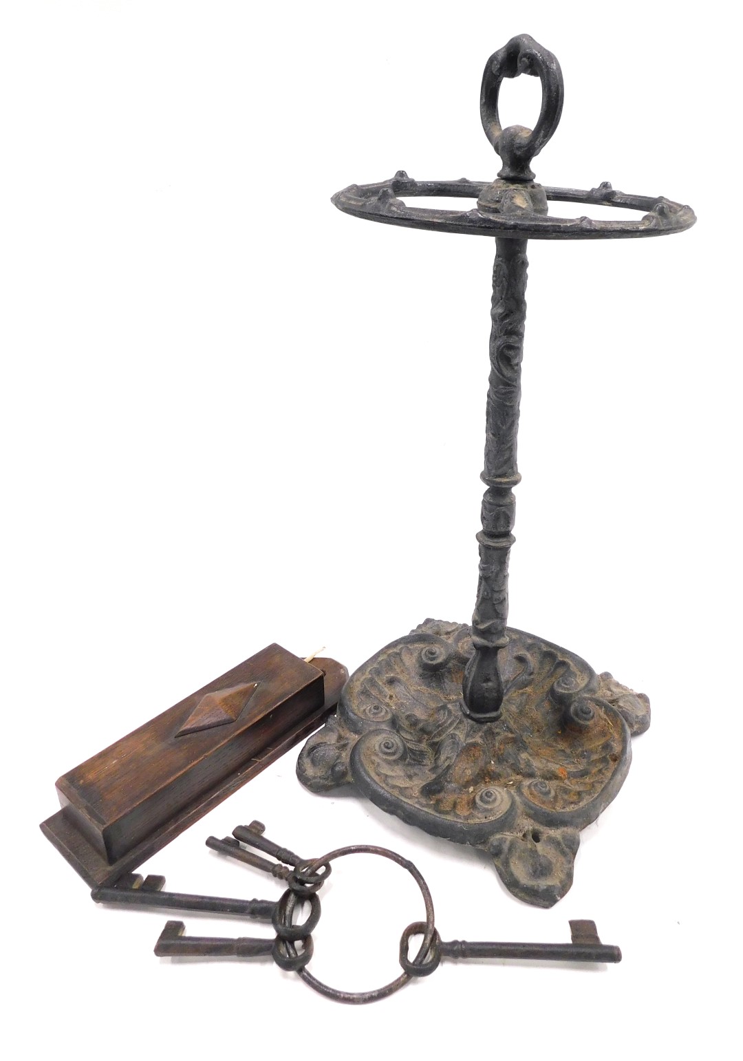 A Victorian style cast iron umbrella stand, oak spill box and a ring with five iron keys.