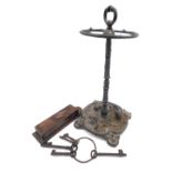 A Victorian style cast iron umbrella stand, oak spill box and a ring with five iron keys.