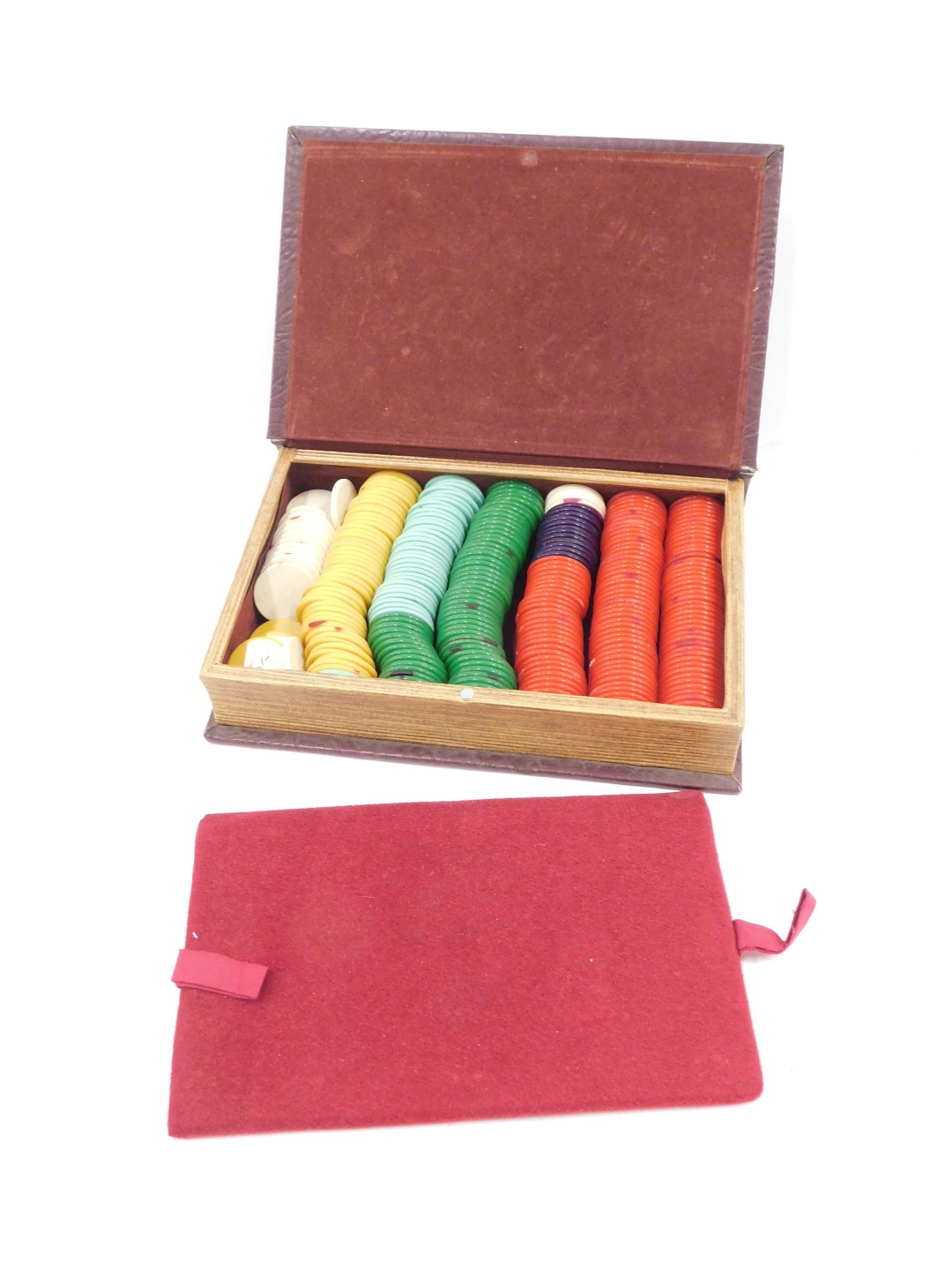 A collection of coloured plastic or Bakelite gaming counters, housed in a box made to simulate a boo