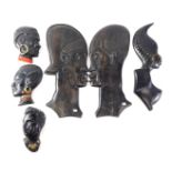 A pair of African wall plaques, each modelled in the form of a bust of a warrior, 36cm high, and oth