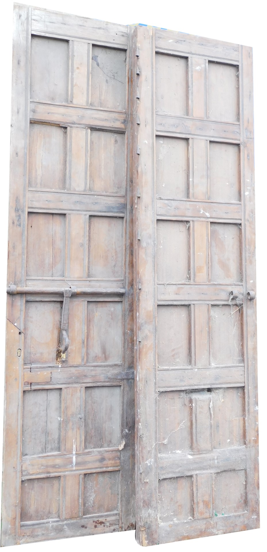 A large pair of Continental pine panelled doors, each with some metal fittings, 270cm x 69cm.