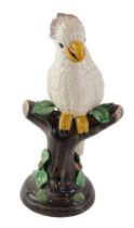 An Italian pottery model of a cockatoo on a perch, 25cm high.