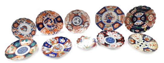 A quantity of Japanese Imari porcelain plates and dishes.