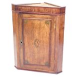 An early 19thC mahogany, oak and marquetry hanging corner cupboard, with single panelled door, 90cm