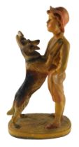 A Chalkware figure of a boy with Alsatian, oval base, indistinctly signed ACM?52, 60cm high.