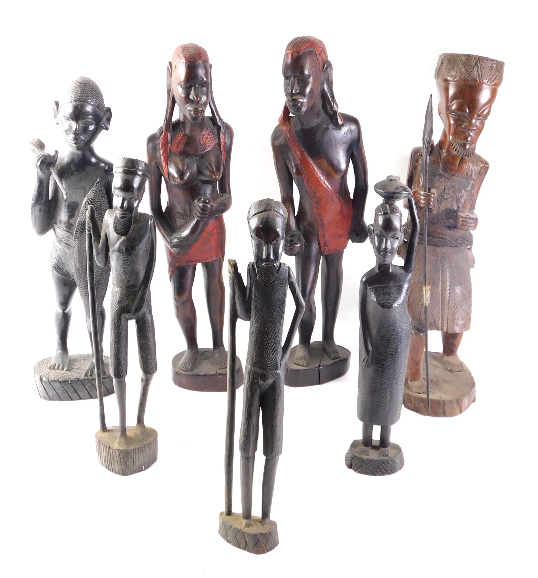 A pair of African tribal male and female figures, each embellished in red, 47cm high, and five other