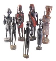 A pair of African tribal male and female figures, each embellished in red, 47cm high, and five other