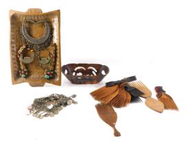 Various silver coloured metal tribal jewellery, tribal combs and a two handled tray.