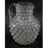 A Victorian glass jug, with raised decoration, 18cm high.