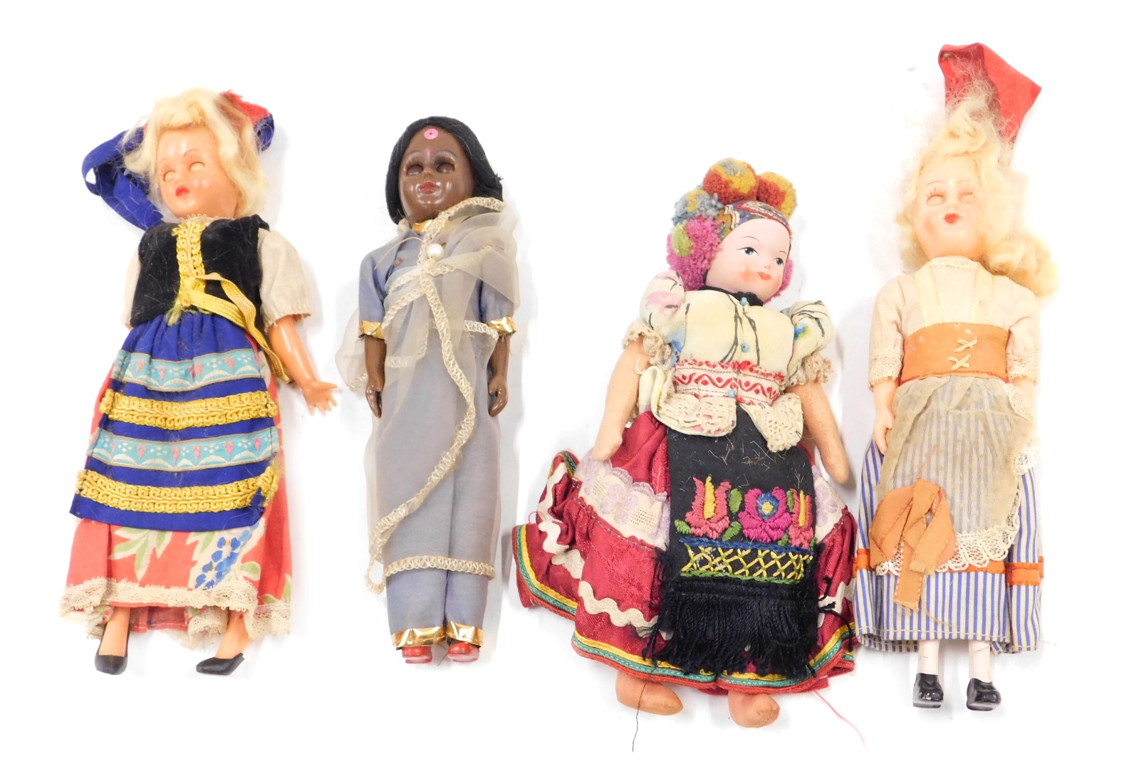 A small collection of costume dolls, each with plastic or fabric limbs. (4)