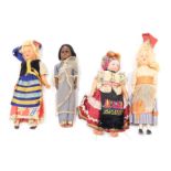 A small collection of costume dolls, each with plastic or fabric limbs. (4)