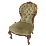 A Victorian show frame nursing chair, with a buttoned back and a padded seat, on cabriole legs with