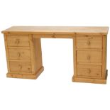 A pine dressing table or desk, with six drawers, on a plinth, 78cm high, 160cm wide.