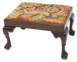 A mahogany stool, in Georgian style, with embroidered woolwork top, on cabriole legs with ball and c