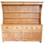 A light oak dresser, in late 18thC style, the plate rack with a moulded cornice and two shelves, the