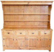 A light oak dresser, in late 18thC style, the plate rack with a moulded cornice and two shelves, the