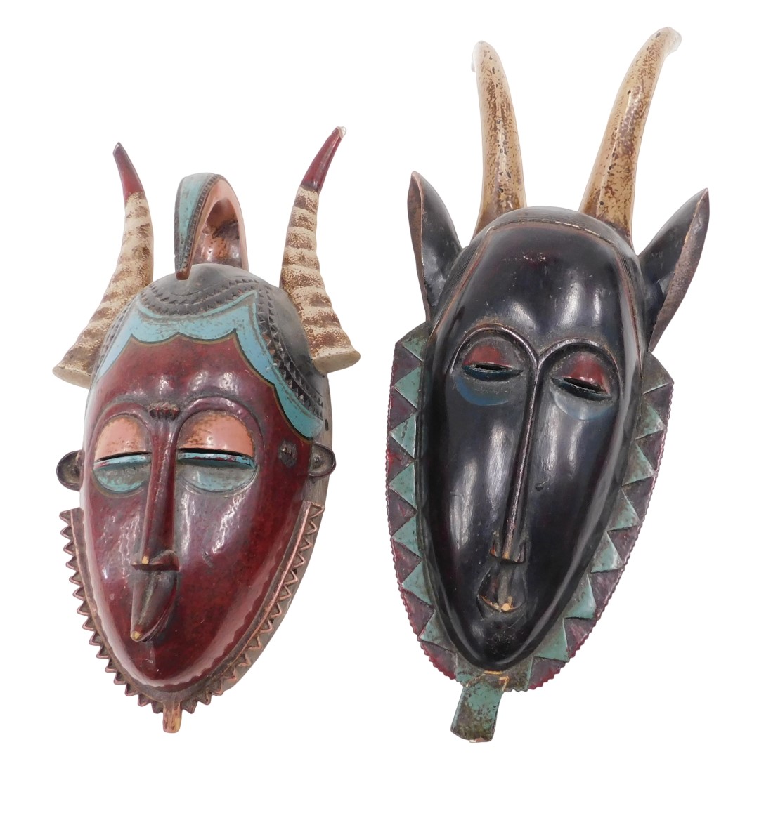 An African tribal mask, with two horns, with a black face, etc., 50cm high, and a similar mask with