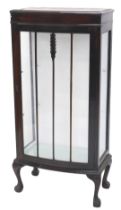 A mahogany bow fronted display cabinet, with a single glazed door, on cabriole legs with ball and cl