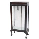 A mahogany bow fronted display cabinet, with a single glazed door, on cabriole legs with ball and cl