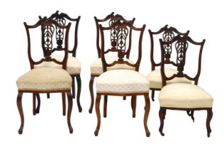 A set of four late 19th/early 20thC walnut salon chairs, each with a shield shaped back, padded seat