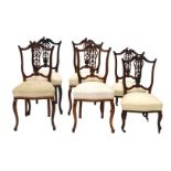 A set of four late 19th/early 20thC walnut salon chairs, each with a shield shaped back, padded seat