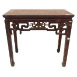 A Chinese red stained altar table, the pierced frieze decorated centrally with a carved stylised bat