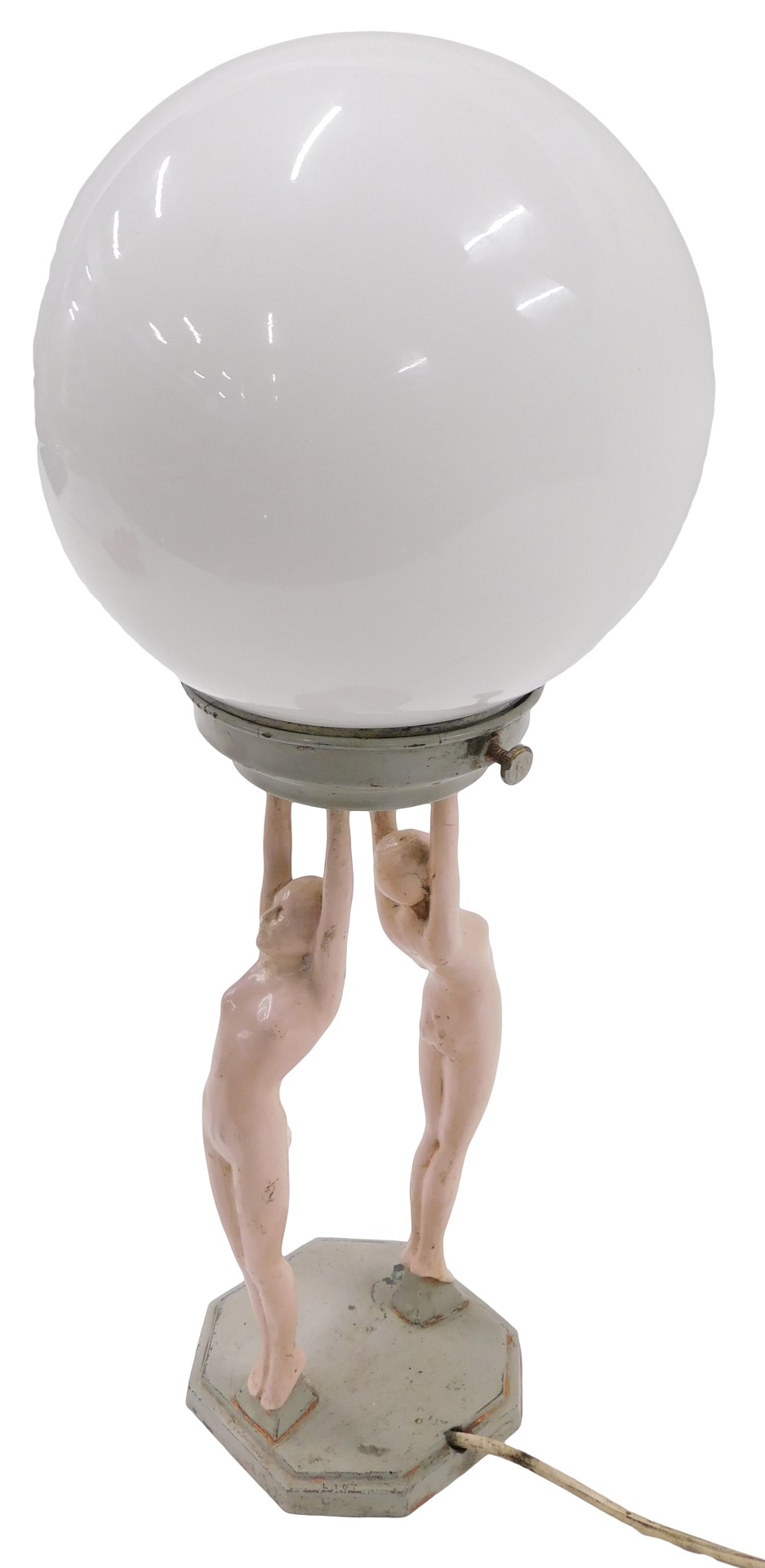 An Art Deco painted metal lamp base, modelled in the form of two nudes holding the opaque glass fitt