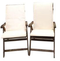 A pair of Royalcraft teak adjustable armchairs, with cream cushions.