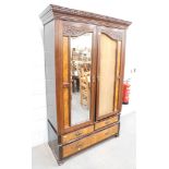 A Victorian mahogany double wardrobe, with burr walnut two single drawer and long drawer base. (AF)