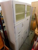 A vintage kitchen cabinet, painted in blue with chrome handles.