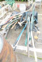 Two wheelbarrows and various garden tools, to include brushes, forks, mallet, rakes, etc.