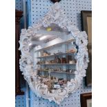 A white plastic finish Rococo style framed wall mirror, with two cherubs, one playing harp.