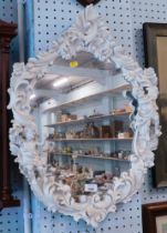 A white plastic finish Rococo style framed wall mirror, with two cherubs, one playing harp.