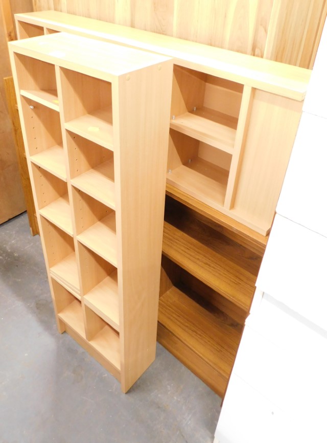 A pair of beech effect CD racks and a bookcase.