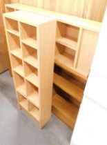 A pair of beech effect CD racks and a bookcase.