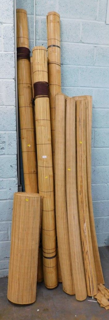 A group of bamboo blinds and matting.