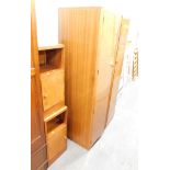 An Art Deco walnut double wardrobe, with moulded front, fitted interior and two bedsides. (3)