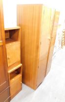 An Art Deco walnut double wardrobe, with moulded front, fitted interior and two bedsides. (3)