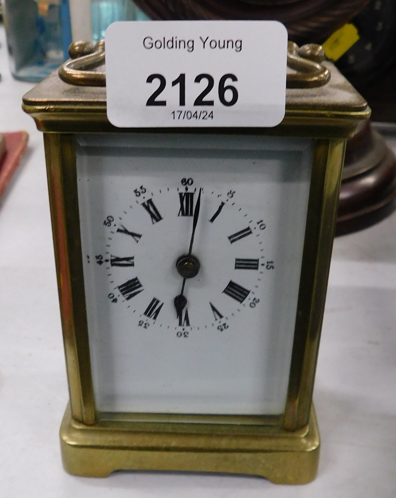 A 20thC brass carriage clock, with an overpainted white enamel Roman numeric dial, on square base, 1