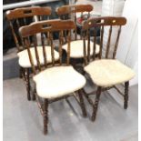 A set of four stained beech pub chairs, each with gold leaf upholstery. The upholstery in this lot